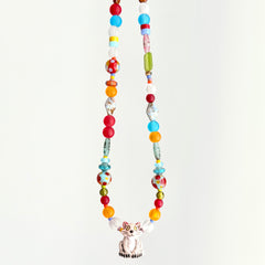 Colorful beaded necklace with a cat-shaped pendant on a white background
